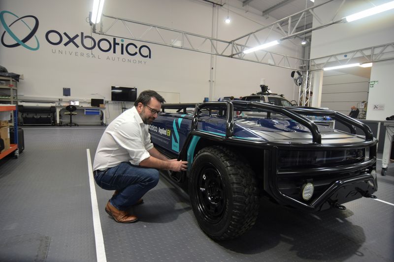 &copy; Reuters. Paul Newman, founder of British autonomous vehicle software startup Oxbotica, is seen next to a converted pickup truck that has been used for test self-driving operations with a mining company, in Oxford, Britain, October 22, 2021. Picture taken October 2