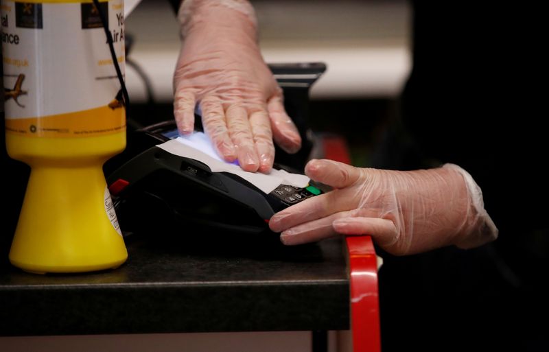 &copy; Reuters. FILE PHOTO: A card machine is cleaned in the village shop 'Browns of Blakesley', following the outbreak of the coronavirus disease (COVID-19), in Blakesley, Britain, April 30, 2020.  REUTERS/Andrew Boyers