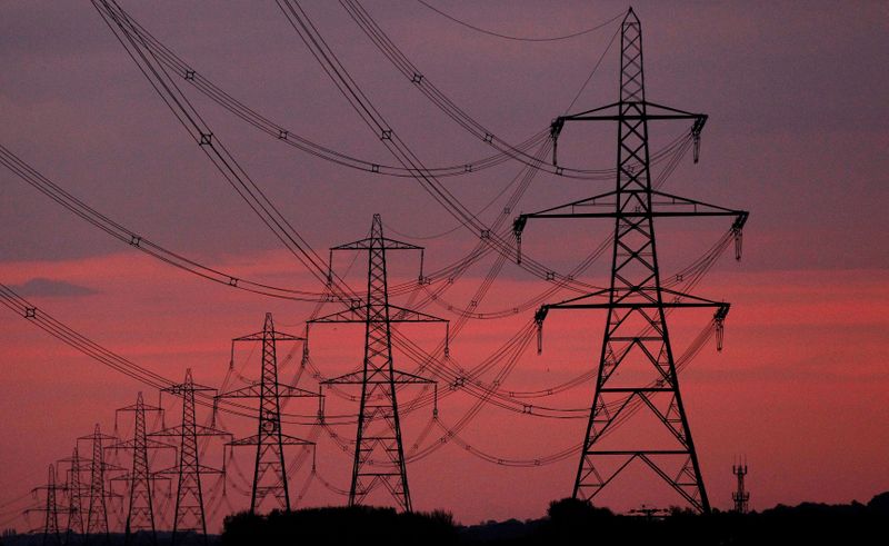 &copy; Reuters. FILE PHOTO: The sun rises behind electricity pylons near Chester, northern England October 24, 2011. REUTERS/Phil Noble/File Photo