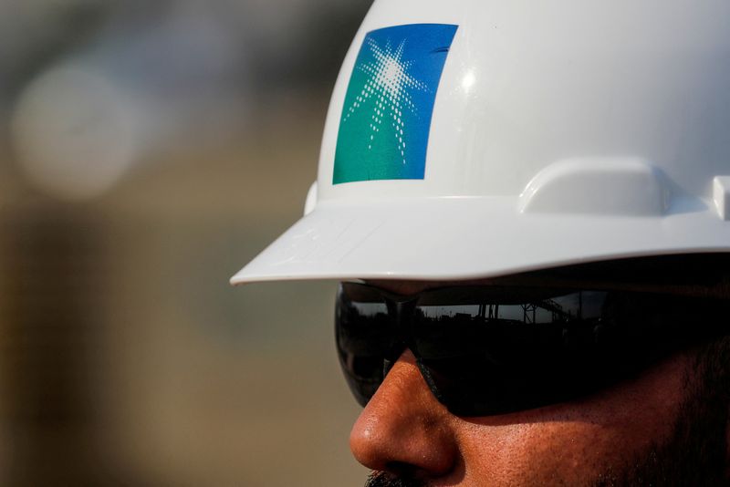 &copy; Reuters. FILE PHOTO: An employee in a branded helmet is pictured at Saudi Aramco oil facility in Abqaiq, Saudi Arabia October 12, 2019. REUTERS/Maxim Shemetov/File Photo