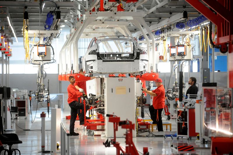 &copy; Reuters. FILE PHOTO: Tesla workers examine a Model S used for training and tool calibration at the company's factory in Fremont, California, June 22, 2012.  REUTERS/Noah Berger/File Photo