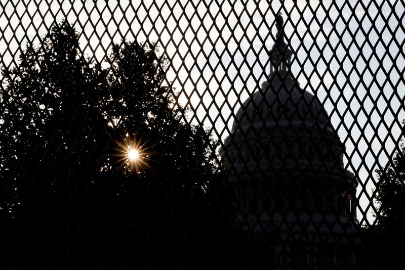 &copy; Reuters. FILE PHOTO: The sun rises behind the U.S. Capitol, surrounded by a security fence ahead of an expected rally Saturday in support of the Jan. 6 defendants in Washington, U.S. September 16, 2021.  REUTERS/Jonathan Ernst/File Photo