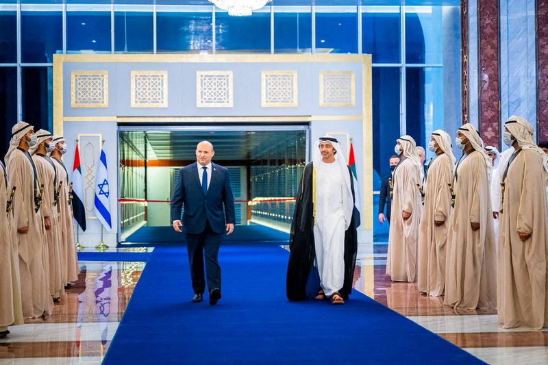 &copy; Reuters. Israeli Prime Minister Naftali Bennett walks with United Arab Emirates Foreign Minister Sheikh Abdullah bin Zayed Al Nahyan during a welcoming ceremony upon his arrival in Abu Dhabi, United Arab Emirates December 12, 2021. WAM/Handout via REUTERS. 