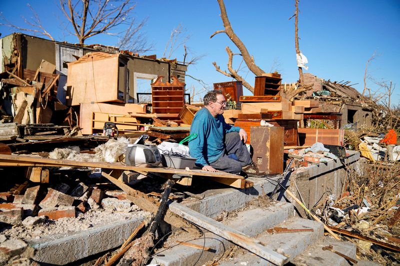&copy; Reuters. Rick Foley, 70, sits outside his home after a devastating outbreak of tornadoes ripped through several U.S. states in Mayfield, Kentucky, U.S. December 11, 2021. "I was in the middle of it, just trying to pull the pieces together now," said Rick who survi