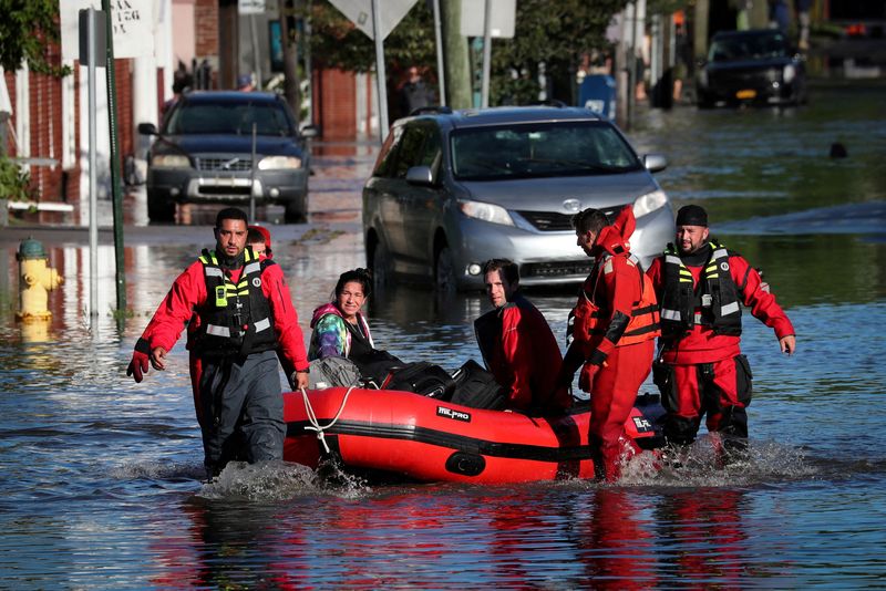 &copy; Reuters. FILE PHOTO: First responders pull local residents in a boat as they perform rescues of people trapped by floodwaters after the remnants of Tropical Storm Ida brought drenching rain,  flash floods and tornadoes to parts of the northeast in Mamaroneck, New 
