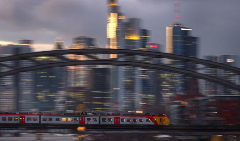 &copy; Reuters. FILE PHOTO: A commuter train passes the skyline in a slow shutter speed photograph as the spread of the coronavirus disease (COVID-19) continues and the country faces new restrictions to control the pandemic in Frankfurt, Germany, December 2, 2021.  REUTE