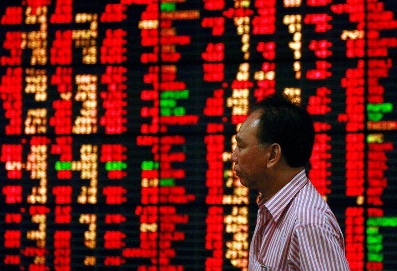 &copy; Reuters. FILE PHOTO: A Thai investor walks past an electronic board displaying live market data at a stock broker's office in central Bangkok August 9, 2011. REUTERS/Chaiwat Subprasom