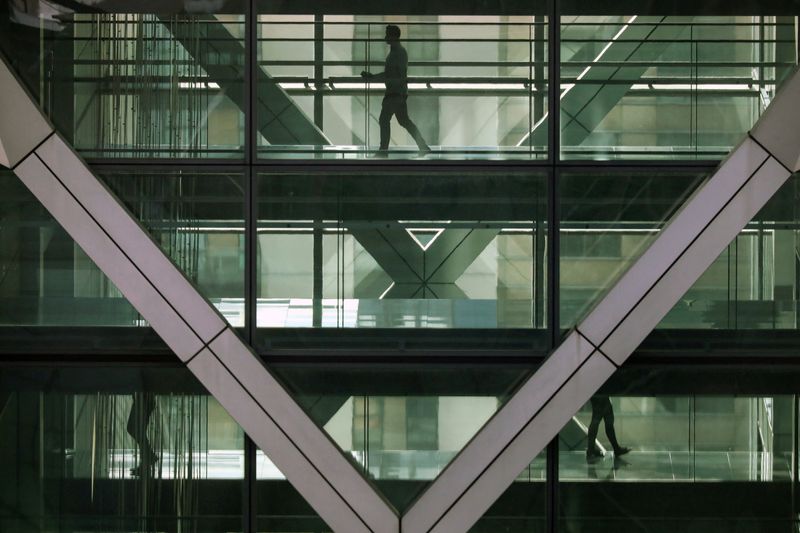&copy; Reuters. FILE PHOTO: People walk in an office in the financial centre of Canary Wharf in London, Britain March 6, 2020. REUTERS/Kevin Coombs