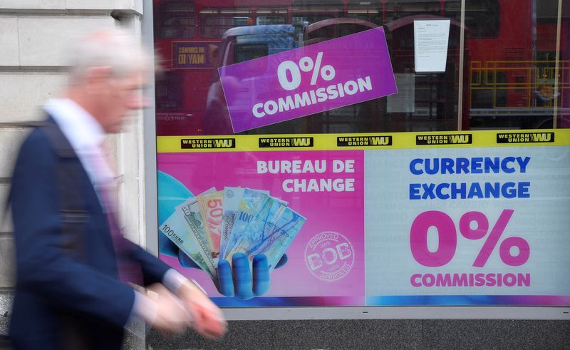 &copy; Reuters. FILE PHOTO: A man walks past a currency exchange outlet in London, Britain, July 31, 2019. REUTERS/Toby Melville/File Photo