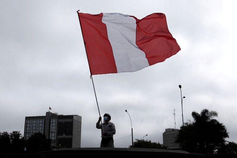 &copy; Reuters. FILE PHOTO: A demonstrator waves a Peruvian flag during a protest against the government of President Pedro Castillo, in Lima, Peru October 8, 2021. REUTERS/Angela Ponce