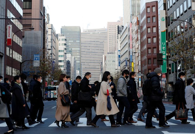 &copy; Reuters. FILE PHOTO: Pedestrians wearing protective masks, following the coronavirus disease (COVID-19) outbreak, make their way during commuting hour at a business district in Tokyo, Japan, January 7, 2021. REUTERS/Kim Kyung-Hoon/File Photo  GLOBAL BUSINESS WEEK 