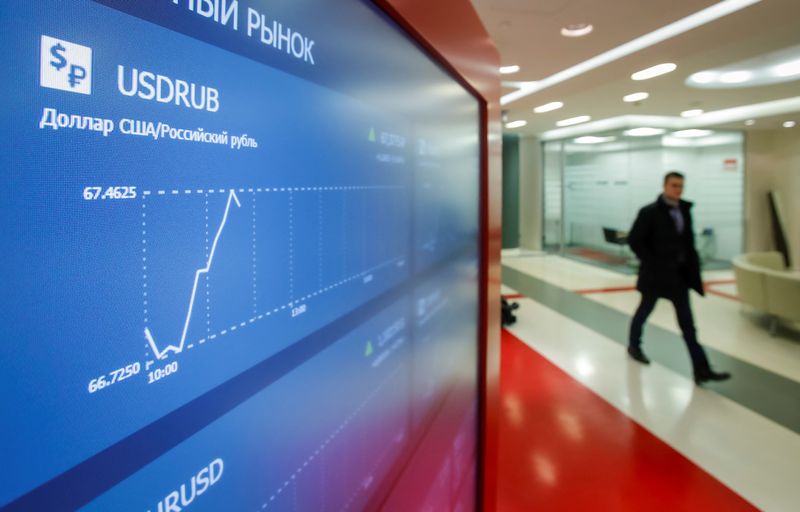 &copy; Reuters. A man walks past an information screen inside the office of the Moscow Exchange in Moscow, Russia February 28, 2020.  REUTERS/Maxim Shemetov