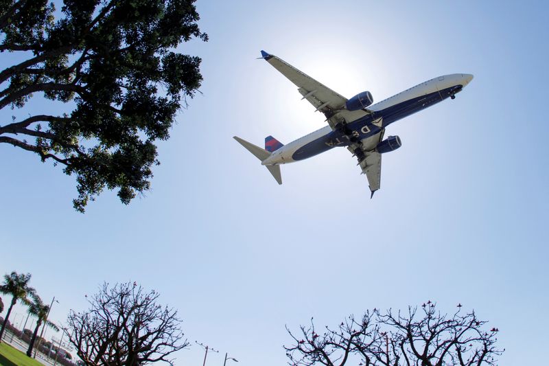 &copy; Reuters. FILE PHOTO: A Delta Airlines passenger jet approaches to land at LAX in Los Angeles, California, U.S., April 7, 2021. REUTERS/Mike Blake/File Photo