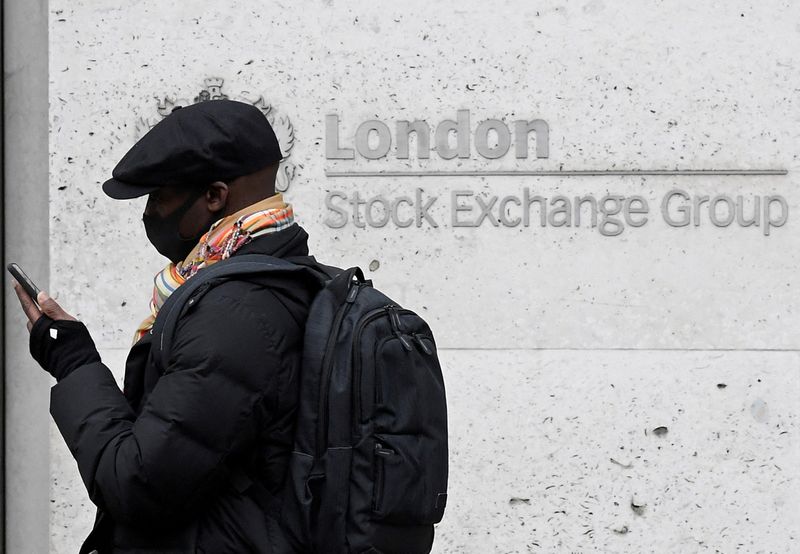 &copy; Reuters. FILE PHOTO: A man wearing a protective face mask walks past the London Stock Exchange Group building in the City of London financial district. March 9, 2020. REUTERS/Toby Melville