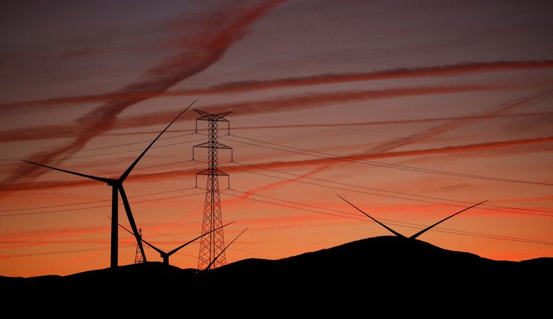 &copy; Reuters. Líneas eléctricas de alta tensión, un pilón eléctrico y aerogeneradores cerca de Pedrola, España, 12 de diciembre de 2021. REUTERS/Albert Gea