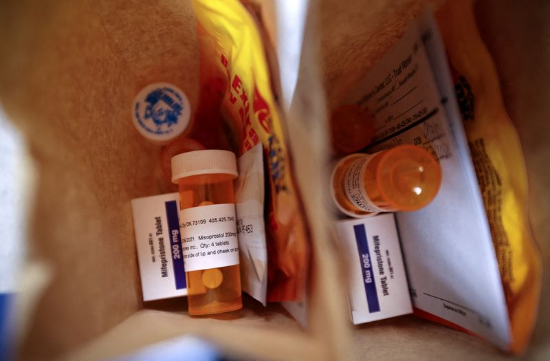 © Reuters. FILE PHOTO: Paper bags containing the medication used for a medical abortion, follow-up instructions, and heating pads are prepared for patients who will be having abortions that day at Trust Women clinic in Oklahoma City, U.S., December 6, 2021. Of the 20 abortions performed that day, 17 of the patients came from Texas. REUTERS/Evelyn Hockstein