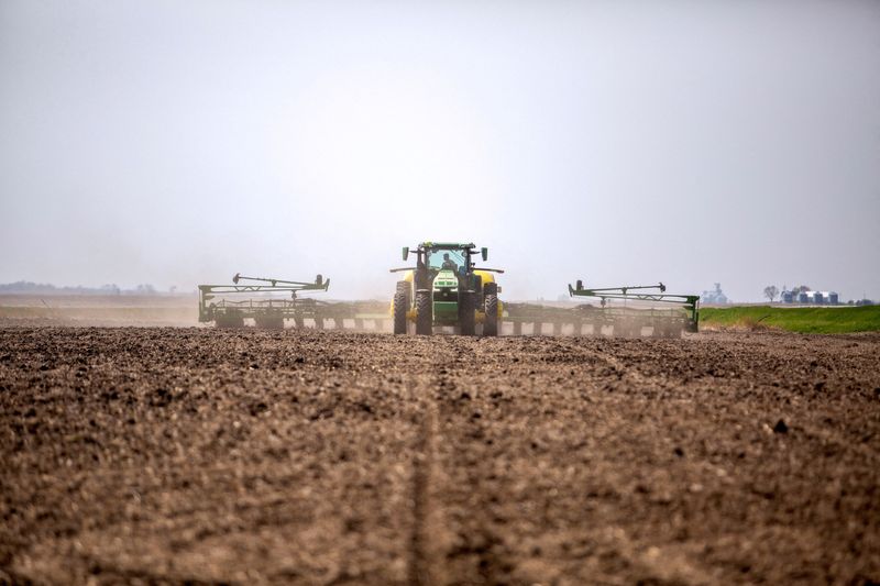 &copy; Reuters. FILE PHOTO: A farmer drives a new tractor and planter during spring planting at a  farm in Malvern, Iowa, U.S., April 27, 2021. 2021.   REUTERS/Rachel Mummey/File Photo