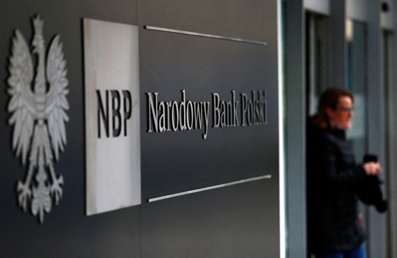 &copy; Reuters. FILE PHOTO: A woman walks out from the National Bank of Poland headquarters in Warsaw March 4, 2015. Poland cut interest rates deeper than expected on Wednesday, bringing them to a new all-time low to curb deflation and prevent excessive gains of its curr