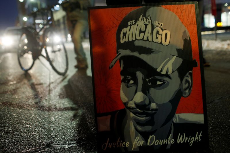 &copy; Reuters. A poster of Daunte Wright is seen during a demonstration after the opening statements in the manslaughter trial of Kimberly Potter, a white former Minnesota police officer charged in the fatal shooting of Daunte Wright, a Black man, whose April death spar