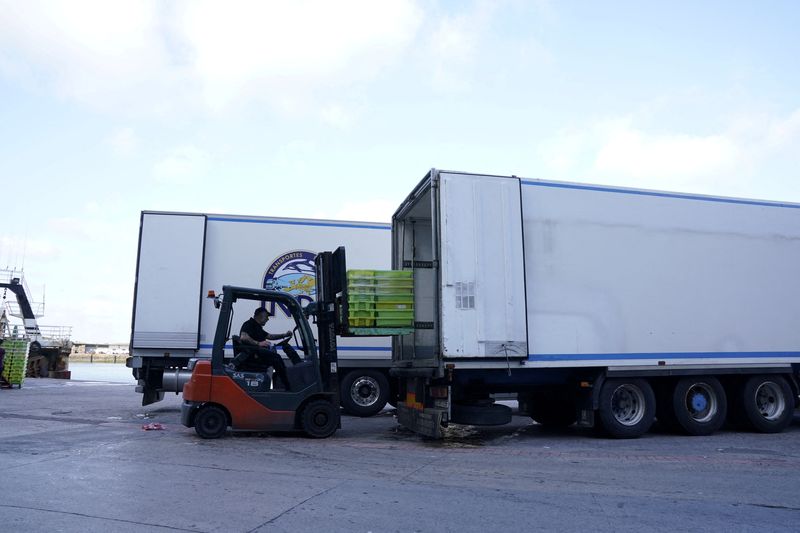 &copy; Reuters. FILE PHOTO: A worker loads fish onto a truck at the Basque port of Ondarroa, amid the global outbreak of the coronavirus disease (COVID-19), Spain, May 17, 2020. Picture taken May 17, 2020. REUTERS/Vincent West/File Photo