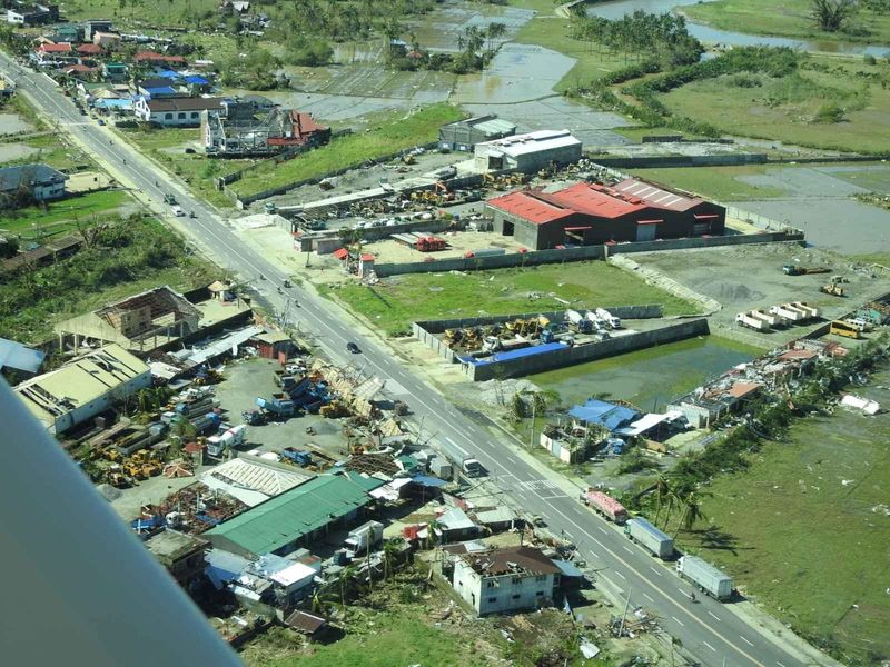&copy; Reuters. FILE PHOTO: Aerial view showing damaged houses in Surigao City, Surigao Del Norte Province, Philippines, December 17, 2021. Picture taken December 17, 2021. Philippine Coast Guard/Handout via REUTERS.