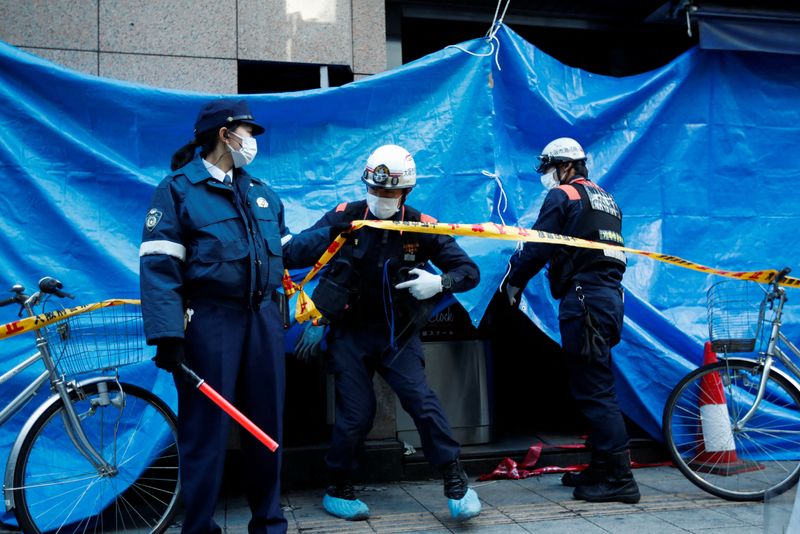 &copy; Reuters. Firefighters work at the building where a fire broke out, in Osaka, Japan December 18, 2021. REUTERS/Kim Kyung-Hoon