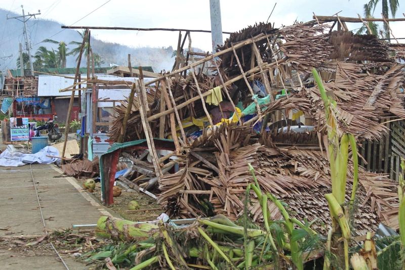 © Reuters. Houses damaged by typhoon Rai are seen, in Surigao del Norte province, Philippines, December 18, 2021. Philippine Coast Guard/Handout via REUTERS