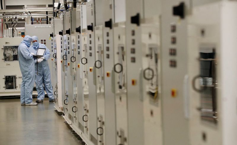 &copy; Reuters. FILE PHOTO: Workers in  protective suits check a computer inside the Envision battery manufacturing plant at Nissan's Sunderland factory, Britain, July 1, 2021. REUTERS/Phil Noble