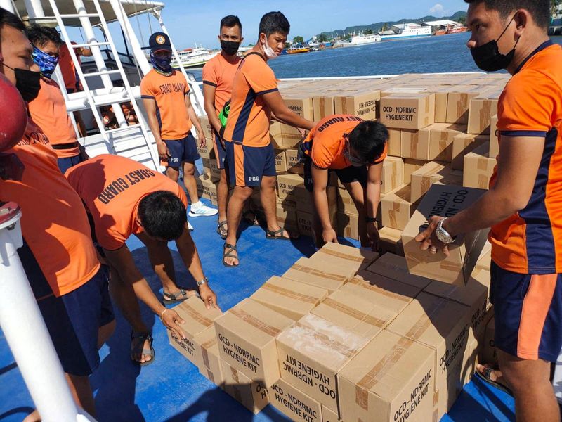 &copy; Reuters. Philippine Coast Guard personnel unload packs of relief goods for victims of Typhoon Rai, in Bacolod City, Negros Occidental, Philippines, December 21, 2021. Philippine Coast Guard/Handout via REUTERS
