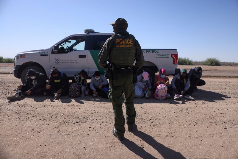 &copy; Reuters. FILE PHOTO: A group of asylum seekers from Mexico, Cuba and Haiti are detained by U.S. Border Patrol in San Luis, Arizona, U.S., April 19, 2021. REUTERS/Jim Urquhart
