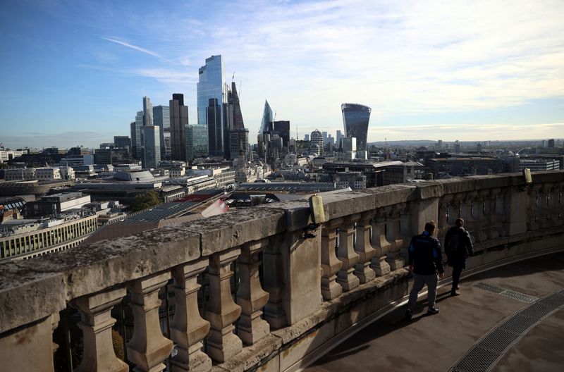 &copy; Reuters. FILE PHOTO: People look out to the City of London financial district from a viewing platform in London, Britain, October 22, 2021. REUTERS/Hannah McKay