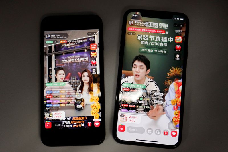 &copy; Reuters. FILE PHOTO: Livestreaming sessions by Chinese livestreamers Li Jiaqi and Viya, whose real name is Huang Wei, (L) are seen on Alibaba's e-commerce app Taobao displayed on mobile phones in this illustration picture taken December 14, 2021. Picture taken Dec