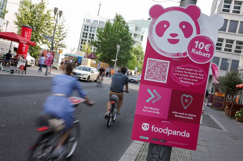 &copy; Reuters. FILE PHOTO: Cyclists drive past an advertisement promoting the grocery delivery company "foodpanda", in Berlin, Germany, August 13, 2021. Picture taken August 13, 2021. REUTERS/Christian Mang