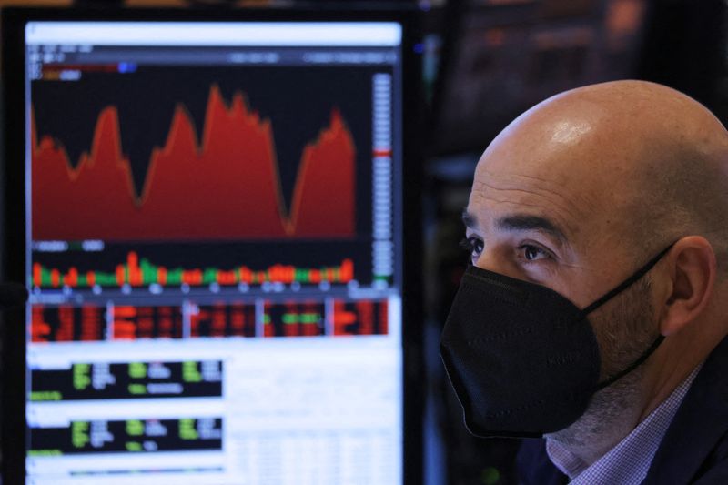 &copy; Reuters. FILE PHOTO: A trader in a face mask works on the trading floor at the New York Stock Exchange (NYSE) as the Omicron coronavirus variant continues to spread in Manhattan, New York City, U.S., December 20, 2021. REUTERS/Andrew Kelly