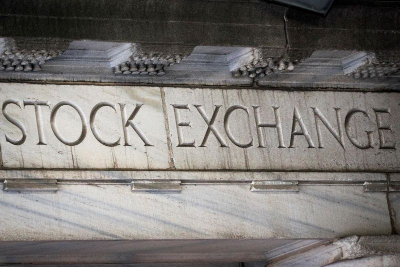 &copy; Reuters. FILE PHOTO: Stock Exchange is seen over an entrance to the New York Stock Exchange (NYSE) on Wall St. in New York City, U.S., March 29, 2021.  REUTERS/Brendan McDermid/File Photo