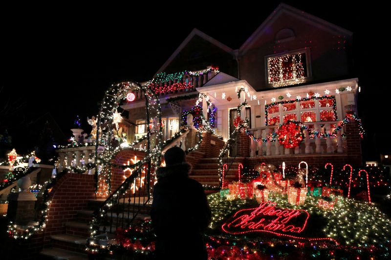 &copy; Reuters. FILE PHOTO: A man stands outside a decorated house at the Dyker Heights Christmas Lights in the Dyker Heights neighborhood of Brooklyn, New York City, U.S., December 23, 2016. REUTERS/Andrew Kelly/File Photo
