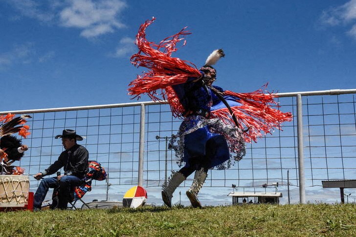 &copy; Reuters. A woman from Dancing Eagles dance troupe from the Osage and Creek tribes performs a dance at an Indian relay race over Memorial Day weekend in Pawhuska, Oklahoma, U.S., May 29, 2021. REUTERS/Stephanie Keith