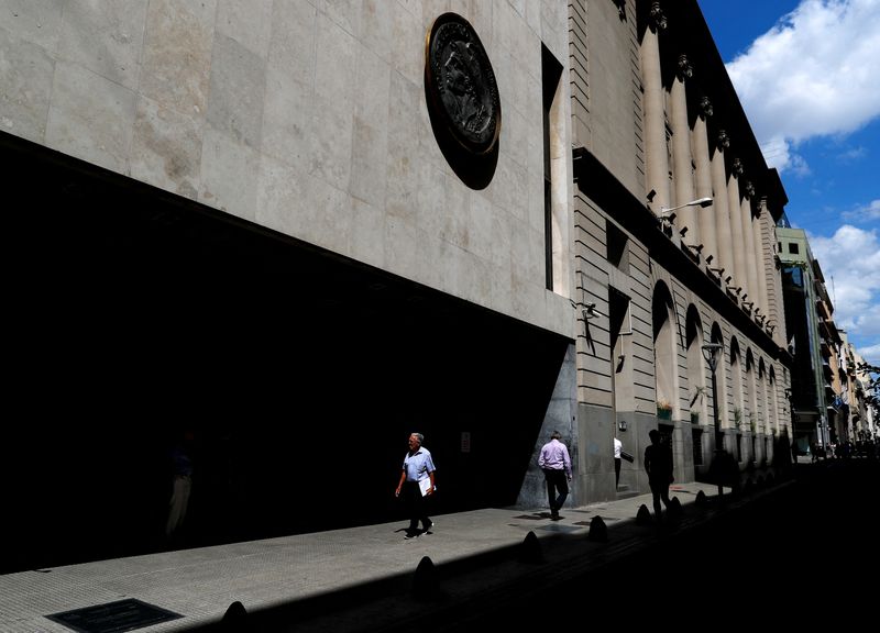 &copy; Reuters. FILE PHOTO: Pedestrians walk past the facade of the Buenos Aires Stock Exchange, in Buenos Aires, Argentina February 26, 2020. REUTERS/Agustin Marcarian