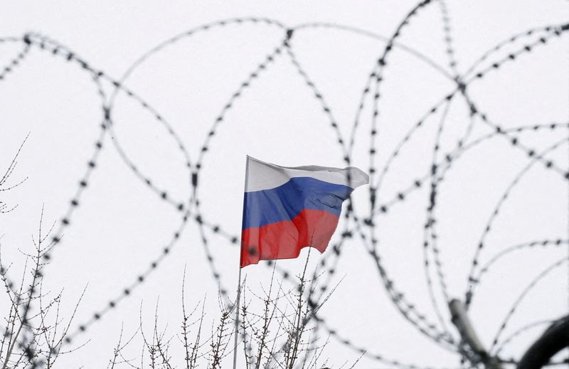 © Reuters. FILE PHOTO: The Russian flag is seen through barbed wire as it flies on the roof of the Russian embassy in Kiev, Ukraine March 26, 2018. REUTERS/Gleb Garanich 