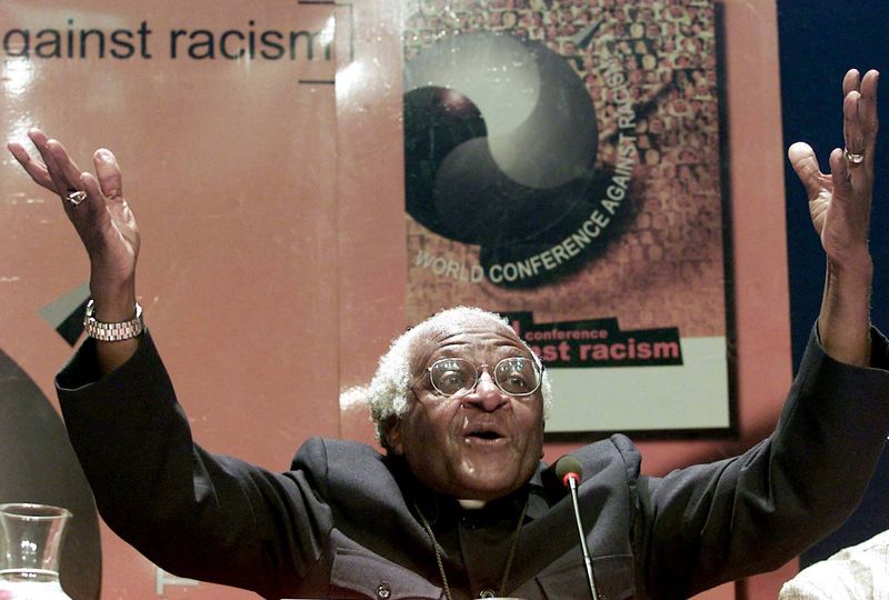 &copy; Reuters. FILE PHOTO: Nobel Peace laureate Archbishop Desmond Tutu gestures as he addresses journalists at the World Conference Against Racism (WCAR), September 5, 2001. Tutu made a call for reparations for slavery saying that they would be like a balm to the wound