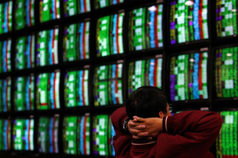 &copy; Reuters. FILE PHOTO: A man looks at stock market monitors in Taipei January 22, 2008. REUTERS/Nicky Loh