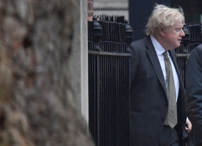 &copy; Reuters. British Prime Minister Boris Johnson walks outside a back entrance to 10 Downing Street, in London, Britain, December 17, 2021. REUTERS/Toby Melville