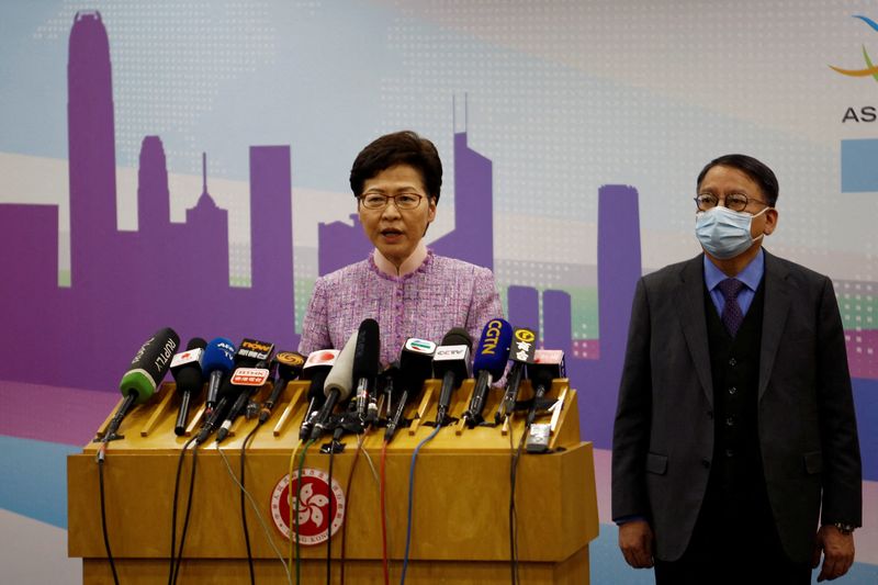 &copy; Reuters. FILE PHOTO: Hong Kong Chief Executive Carrie Lam speaks next to Eric Chan Kwok-ki, director of the Chief Executive's Office, at a news conference in Beijing, China December 22, 2021. REUTERS/Shubing Wang/File Photo