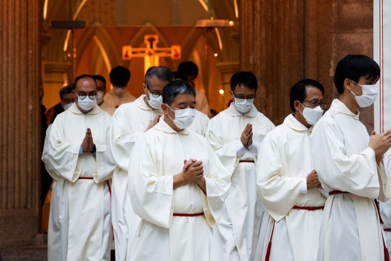 &copy; Reuters. FILE PHOTO: Catholic priests leave the church after the episcopal ordination of Bishop Stephen Chow in Hong Kong, China December 4, 2021. REUTERS/Tyrone Siu/File Photo