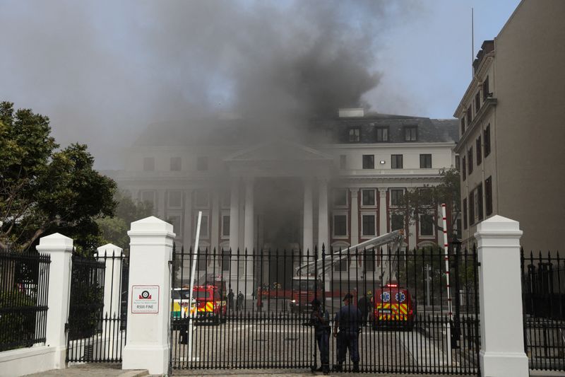 &copy; Reuters. Firefighters work among the smoke after a fire broke out in the Parliament in Cape Town, South Africa, January 2, 2022. REUTERS/Sumaya Hisham