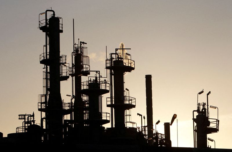 &copy; Reuters. FILE PHOTO: Towers and smokestacks are silhouetted at an oil refinery in Melbourne June 21, 2010.  REUTERS/Mick Tsikas/File Photo
