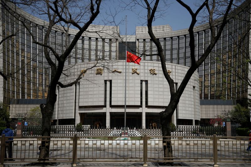 &copy; Reuters. FILE PHOTO: The Chinese national flag flies at half-mast at the headquarters of the People's Bank of China, the central bank (PBOC), as China holds a national mourning for those who died of the coronavirus disease (COVID-19), on the Qingming tomb-sweeping