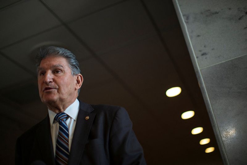 © Reuters. U.S. Senator Joe Manchin (D-WV) speaks to news reporters outside of his office in the Hart Senate Office Building on Capitol Hill in Washington, U.S., January 4, 2022. REUTERS/Tom Brenner