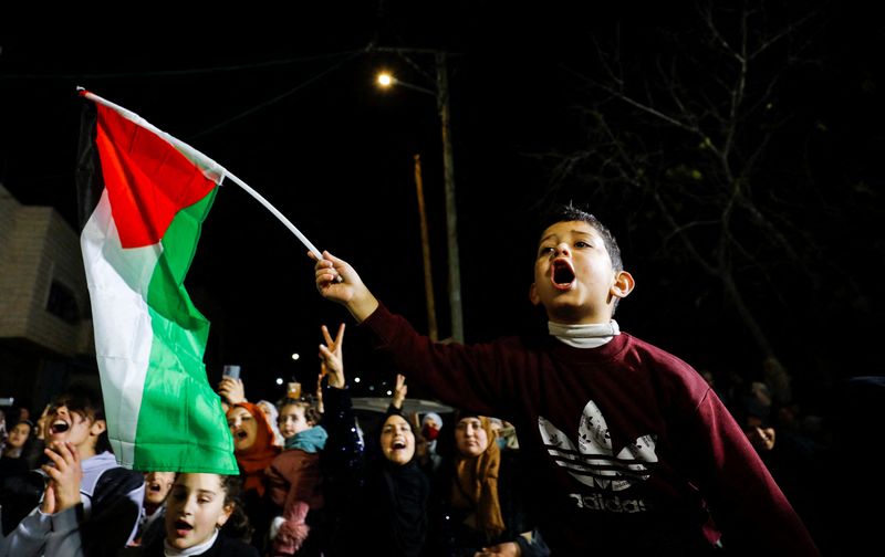 &copy; Reuters. Relatives of Palestinian prisoner Hisham Abu Hawash, who is held by Israel, celebrate after he ended his hunger strike, in Dura, in the Israeli occupied West Bank, January 4, 2022. REUTERS/Mussa Qawasma