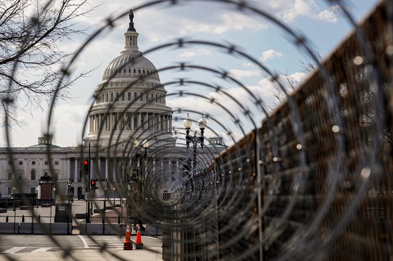 &copy; Reuters. FILE PHOTO: The U.S. Capitol is seen through razor wire in Washington, U.S., March 4, 2021. REUTERS/Joshua Roberts/File Photo